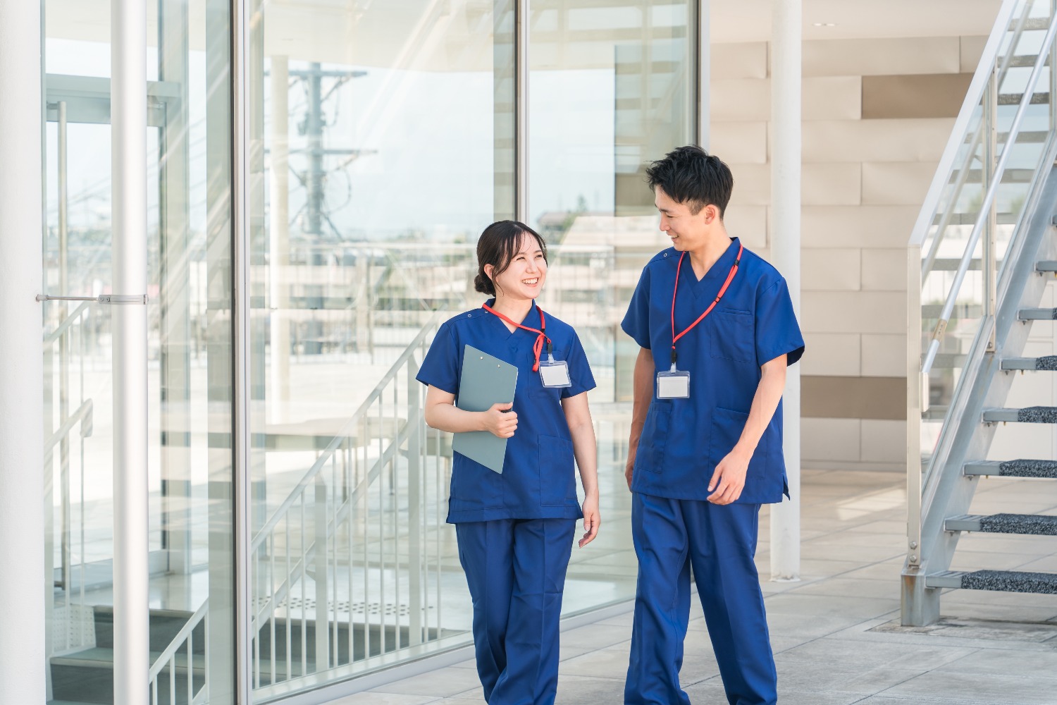 Two people in scrubs talking