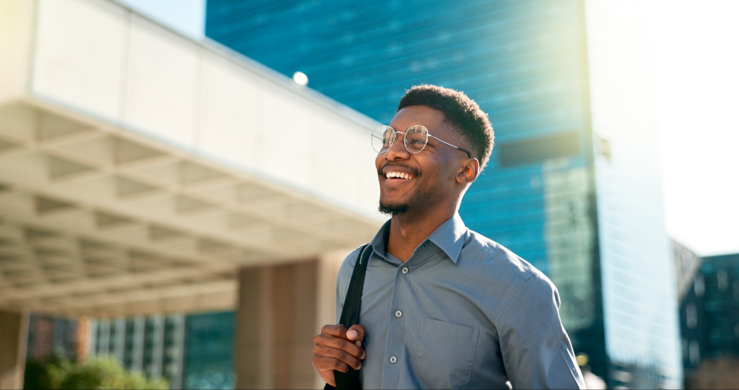 Man smiling holding backpack