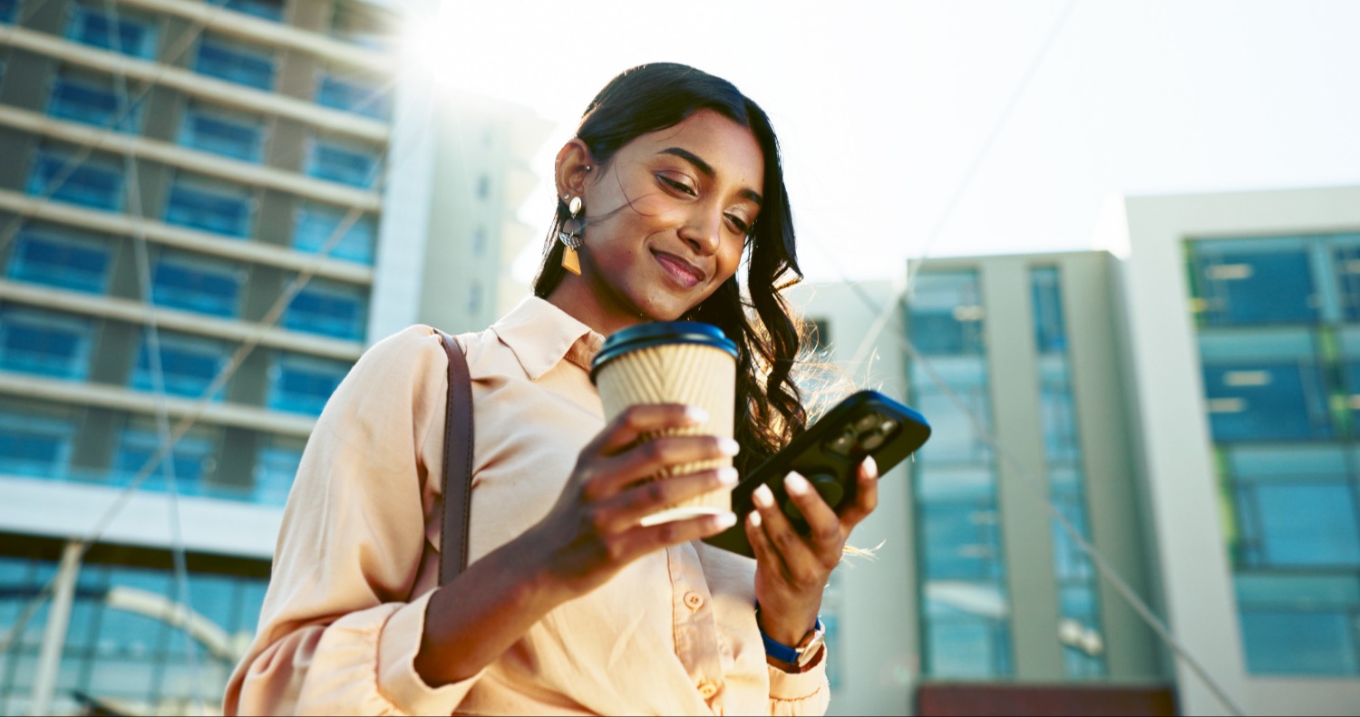 Smiling woman using phone