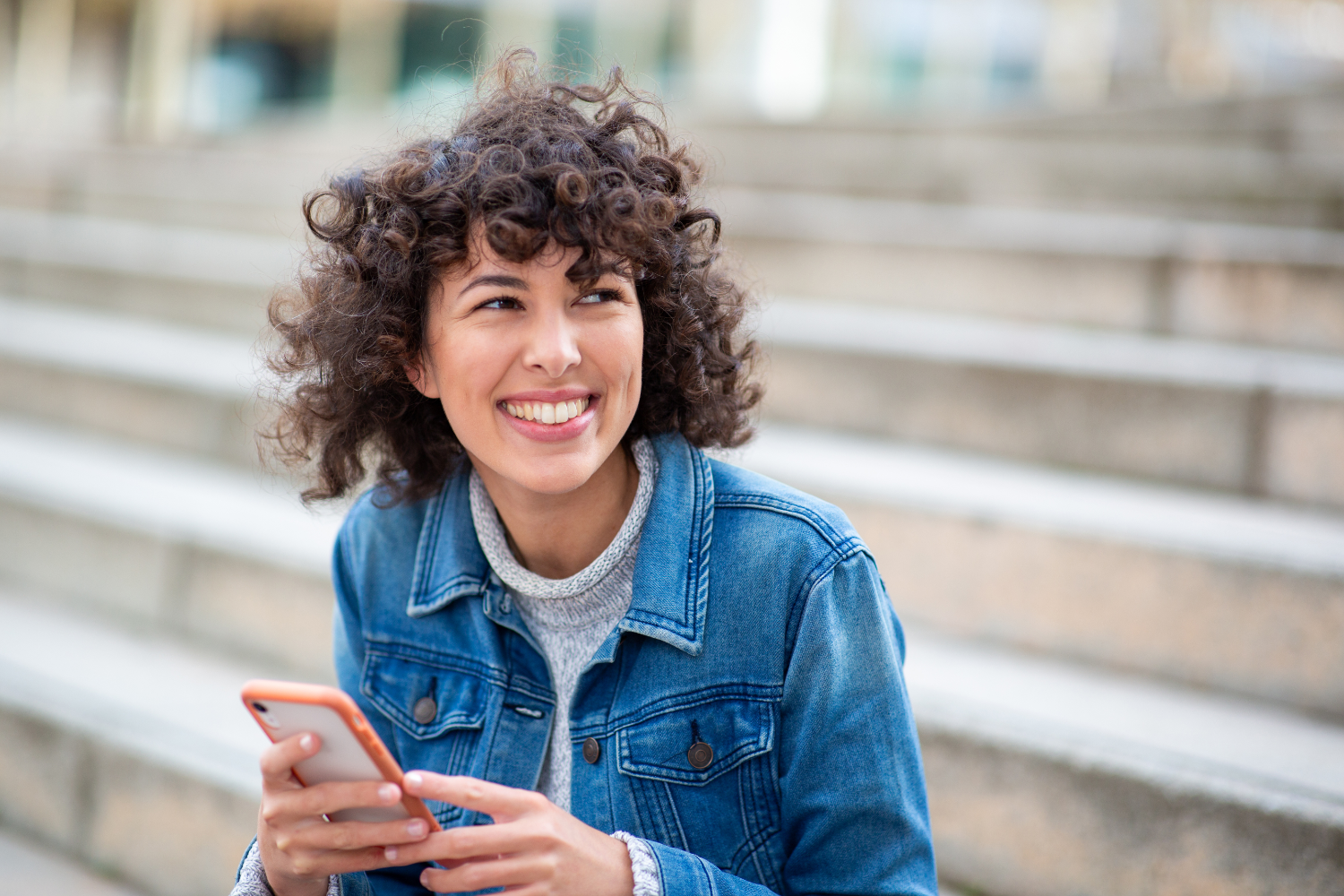 Smiling woman using phone