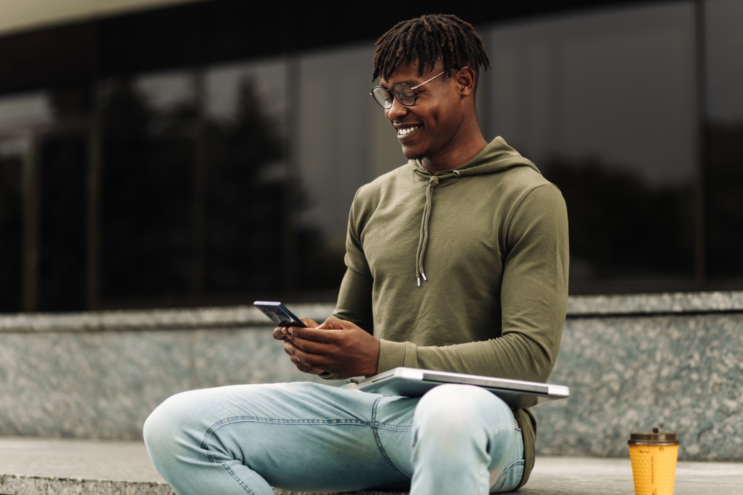 Smiling man using phone