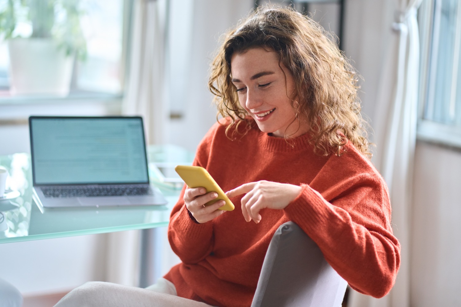 Smiling woman using phone