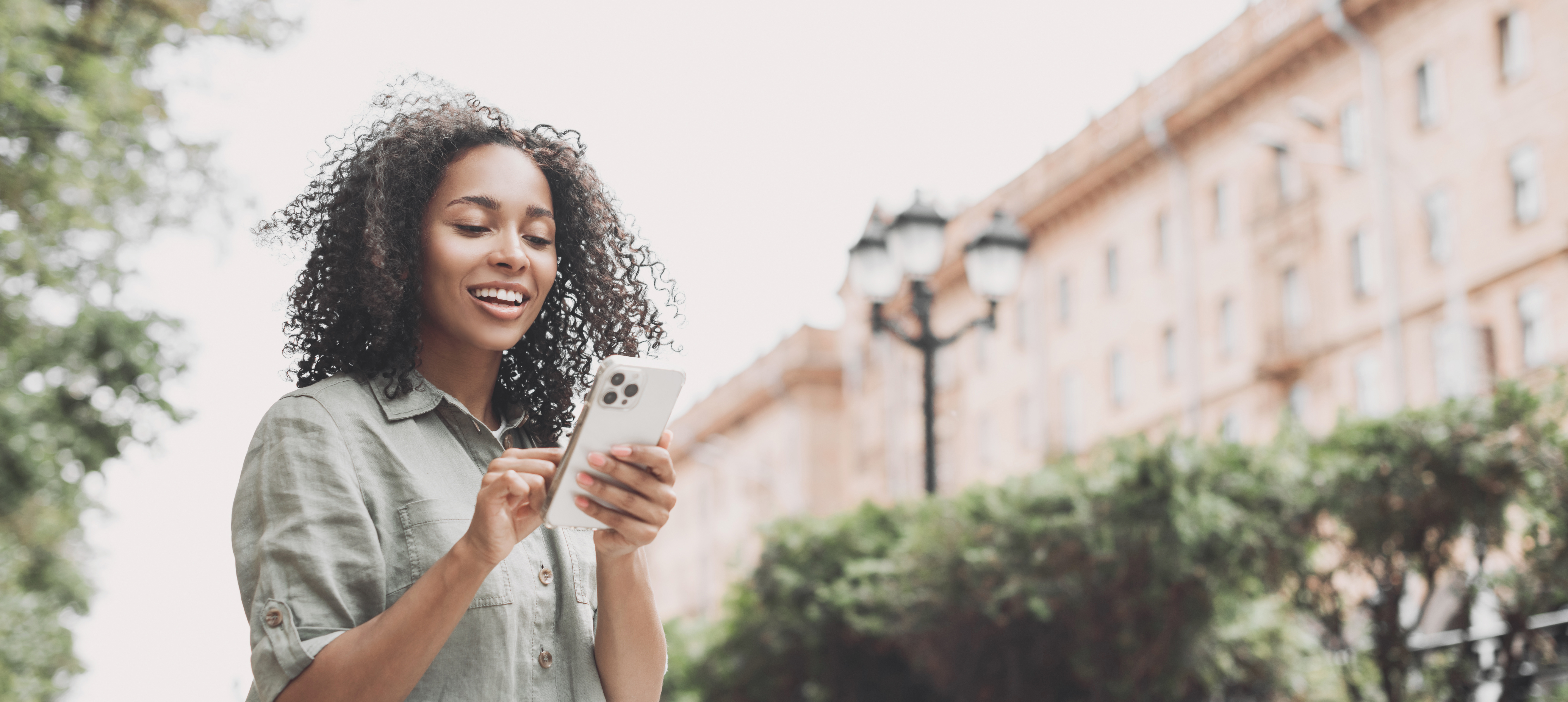 Smiling woman using phone
